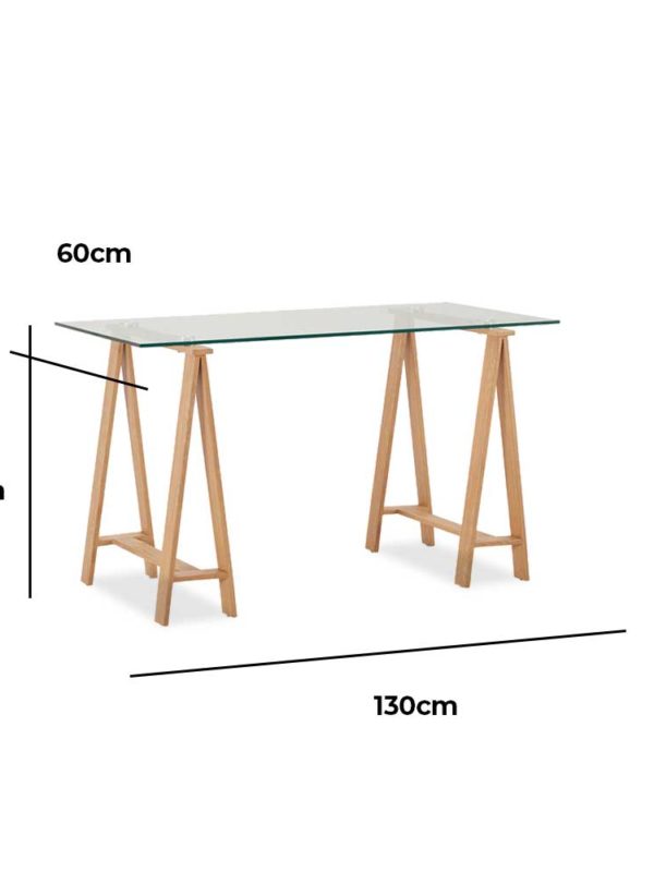Waverley Trestle Desk, is a boss glass tabletop and metal legs finished in an oak-coloured foil.